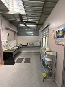 a large kitchen with a sink and a counter at PRS Homestay in Chemor +36 photos