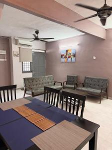 a room with a table and chairs and a ceiling fan at PRS Homestay in Chemor