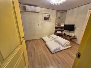 a room with two white pillows on the floor at Hundred Years Hanok in Mokpo