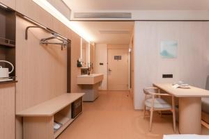 a bathroom with a sink and a table in a room at JI Hotel Nanjing Gulou Square in Nanjing +18 photos