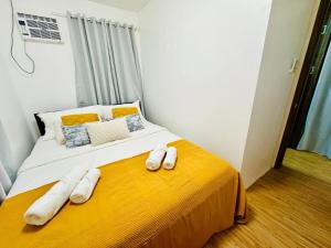 a bedroom with a bed with towels on it at Casa Del Sol! 2BR Puerto Princesa in Puerto Princesa City +14 photos
