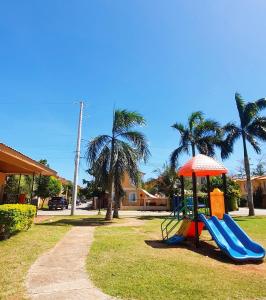 a playground with a slide and an umbrella at Casa Del Sol! 2BR Puerto Princesa in Puerto Princesa City