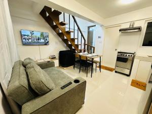 a living room with a couch and a table at Casa Del Sol! 2BR Puerto Princesa in Puerto Princesa City