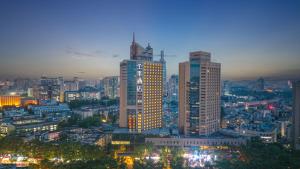 a city skyline with tall buildings at night at JI Hotel Nanjing Gulou Square in Nanjing