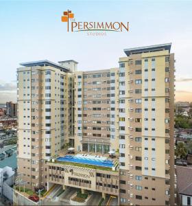 a large building with a swimming pool in front of it at Jo Condotels at Persimmon Tower3 in Cebu City