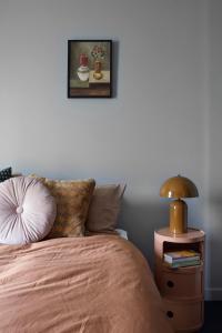 a bedroom with a bed and a table with a lamp at Eastlake Retreat Kingston in Kingston  +10 photos