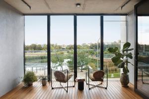 a room with three chairs and a large window at Eastlake Retreat Kingston in Kingston 