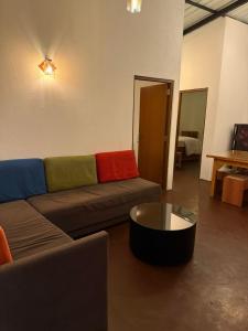 a living room with a couch and a coffee table at Mount Boutique Villa in Kandy