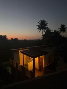 a house with a gazebo in front of a sunset at Mount Boutique Villa in Kandy