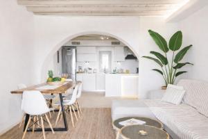 a living room with a table and a couch at Hyperion Villa by LLB Mykonos in Klouvas
