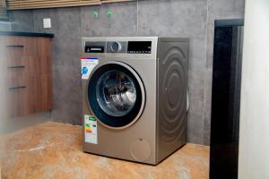 a washing machine is sitting in a kitchen at Wangu Urban in Mpemba