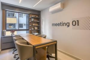 a meeting room with a wooden table and chairs at Ancorar Hospedagens in João Pessoa +88 photos