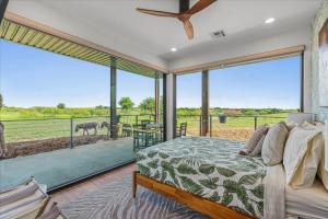 a bedroom with a bed and a large window at Blue Hills Ranch in McGregor +249 photos