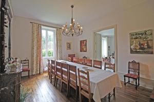 a dining room with a table and some chairs at Brenac in Eymoutiers