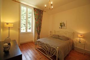 a bedroom with a bed and a window at Brenac in Eymoutiers +56 photos