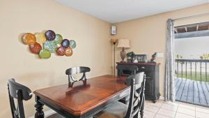 a dining room with a wooden table and chairs at Sixty-Five & Salty Bay View 65 in Orange Beach +22 photos