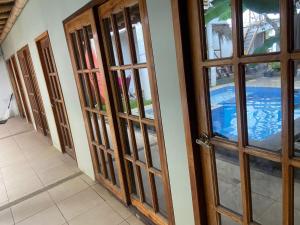 a row of doors in a room with a pool at Villa en Salango con piscina in Salango +4 photos