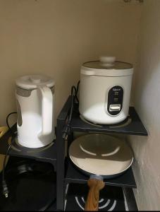 a coffee maker and a toaster on a shelf at Zara Residence Room1 in Lagao