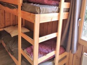 a couple of bunk beds in a room at Chalet accessible - 4 pers - Terrasse - API-1-52-1278 in Challes-les-Eaux