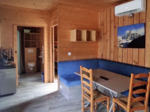 a room with a table and chairs in a cabin at Chalet accessible - 4 pers - Terrasse - API-1-52-1278 in Challes-les-Eaux +17 photos