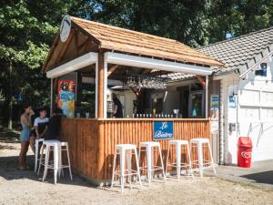 a bar with white stools at Chalet accessible - 4 pers - Terrasse - API-1-52-1278 in Challes-les-Eaux