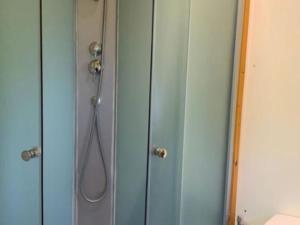 a shower in a bathroom with a glass door at Chalet 2 Pers avec Terrasse à Challes-les-Eaux - API-1-52-1283 in Challes-les-Eaux