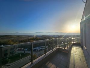 a balcony of a building with the sunset in the background at Desitas home in Plovdiv