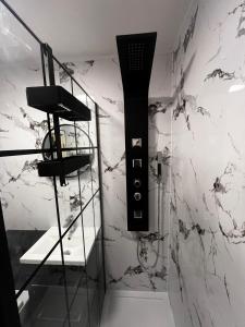 a bathroom with a black and white marble wall at Seaside Penthouse 2 in Largs +14 photos