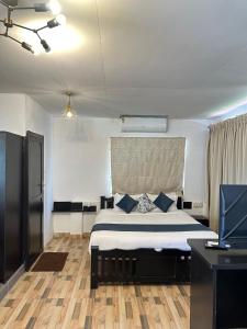 a bedroom with a large bed with blue pillows at BRICK CASTLE in Chennai +38 photos