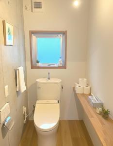 a bathroom with a white toilet and a window at Sunshine in Tokyo +10 photos