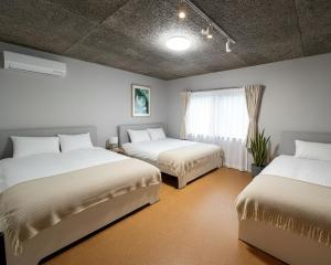a bedroom with two beds and a window at Sunshine in Tokyo