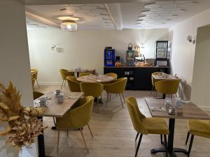 a restaurant with tables and chairs and a counter at Hôtel Comme chez soi in Jas