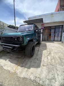 a green truck parked in front of a building at Ulya Kecil in Diyeng