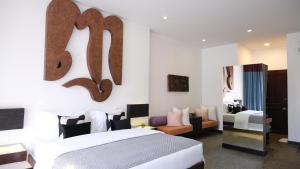 a hotel room with a bed and a mirror at Golden Temple Villa in Siem Reap