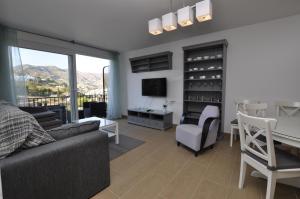 A television and/or entertainment centre at Casas Adosadas Lambda