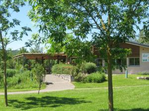 a building with a garden in front of it at Chalet 8 Pers - Terrasse - Equipement bébé - API-1-52-1519 in Beaudreix