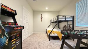a bedroom with a bunk bed and a game table at 5 mins to NRG and The Medical Center The Houston Reston in Houston