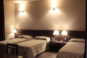 Postel nebo postele na pokoji v ubytování Hotel Le Badie
