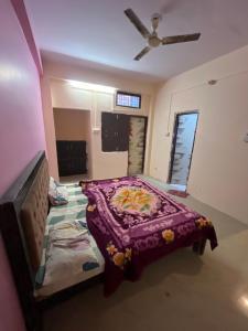 a bedroom with a bed and a ceiling fan at Hotel flamingo inn in Rewa