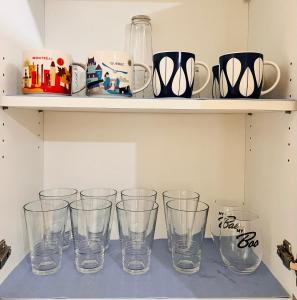 a row of empty glasses sitting on a shelf at New 1BR in Mandaluyong 40SQM in Manila