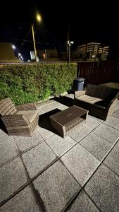 a table and chairs on a sidewalk at night at Condo luminity exclusivo 2D-2B incluye piscina parking y wifi gratis check in y seguridad 24 hrs in Los Ángeles