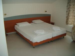 a bed with two white pillows on it in a room at Hotel Babeva in Sveti Vlas