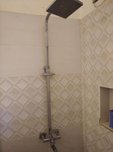 a bathroom with a shower with a ceiling fan at Negombo New Villa in Negombo