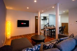 a living room with a couch and a dining room at Villa Shigin in Nakafurano