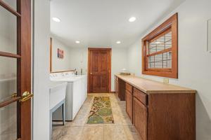 a kitchen with a sink and a wooden door at Twin Fawns - EV #3417 in Estes Park