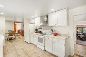 a kitchen with white appliances and a dining room at Twin Fawns - EV #3417 in Estes Park +21 photos
