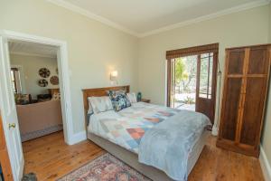 a bedroom with a bed and a sliding glass door at Deer Cottage in Kirkwood
