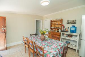 a dining room with a table with a vase on it at Deer Cottage in Kirkwood +12 photos