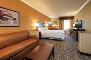 a hotel room with a bed and a couch at Holiday Inn Express Castro Valley - I-580 by IHG in Castro Valley +45 photos