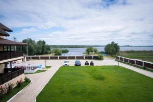 arial view of a parking lot with a view of a lake at Danubiu Resort in Murighiol